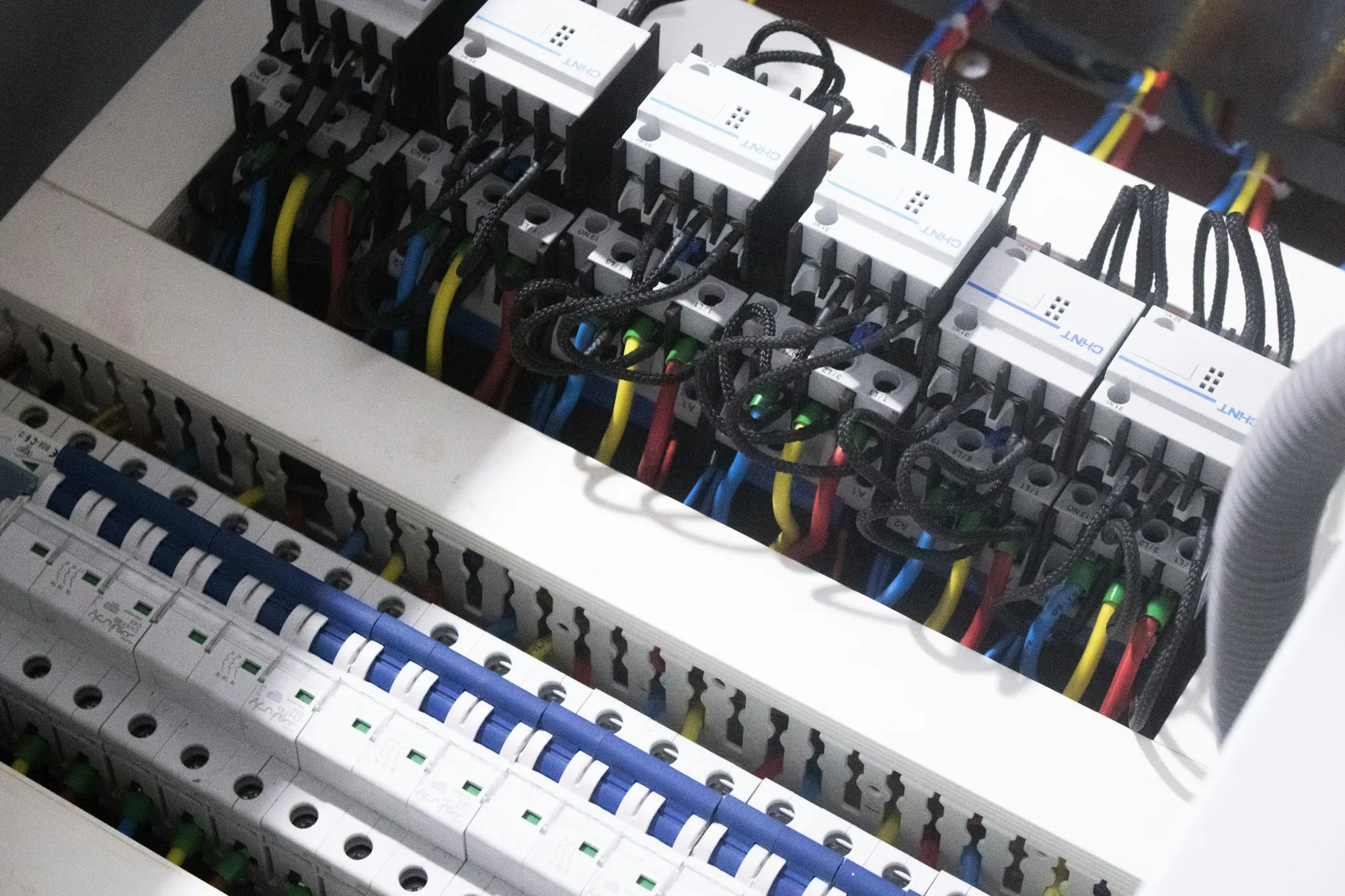 Rows of new circuit breakers in an open electrical panel