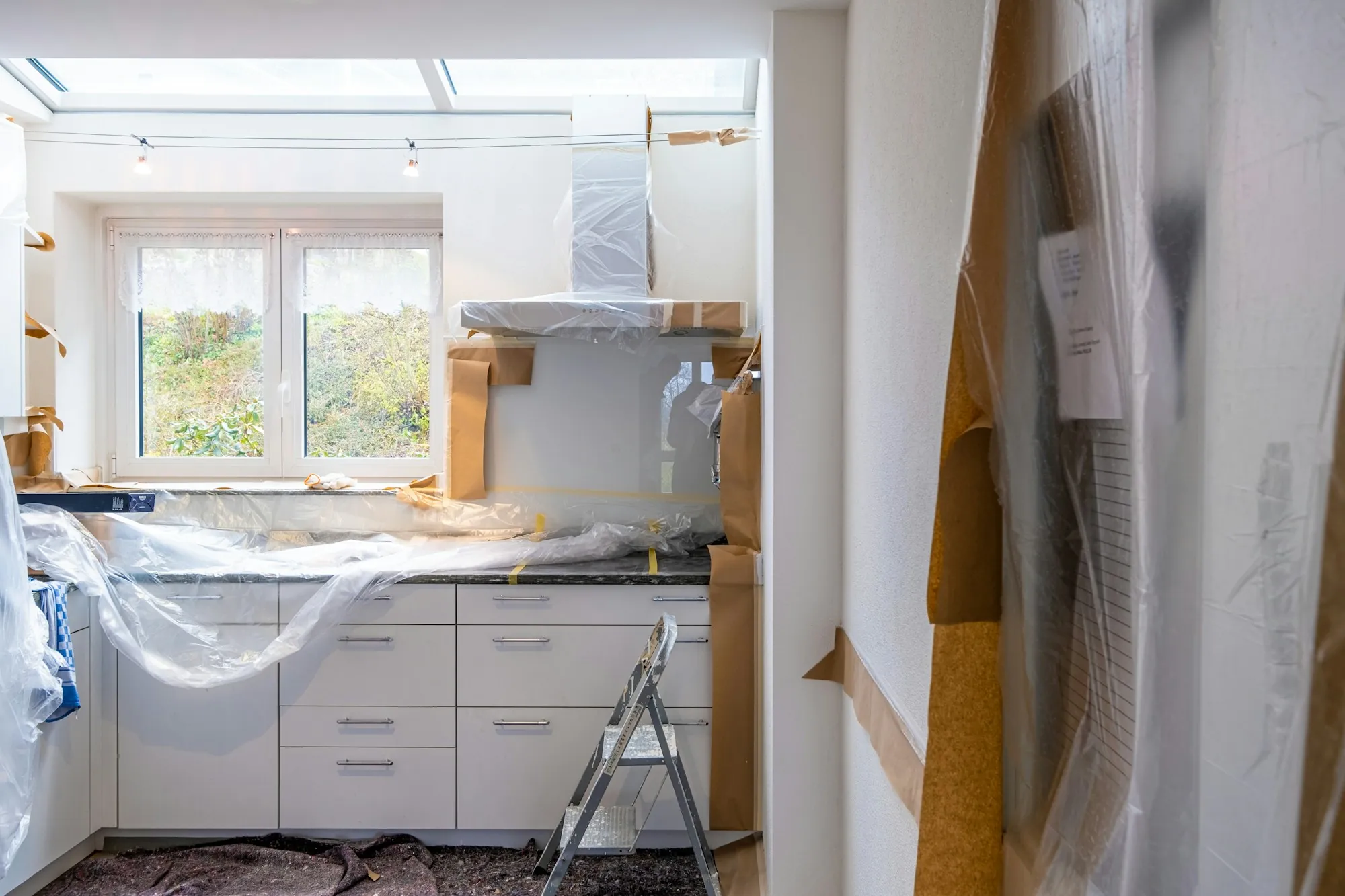 Kitchen under renovation with open walls and new cabinets going in